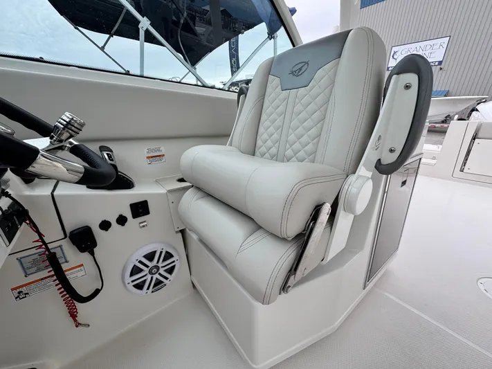  Yacht Photos Pics Captain's seat on 2025 Sailfish 316 DC boat, featuring quilted upholstery and modern controls.