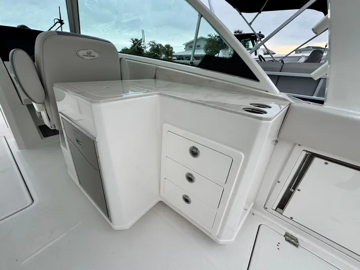  Yacht Photos Pics 2025 Sailfish 316 DC boat interior with storage drawers and seating area.