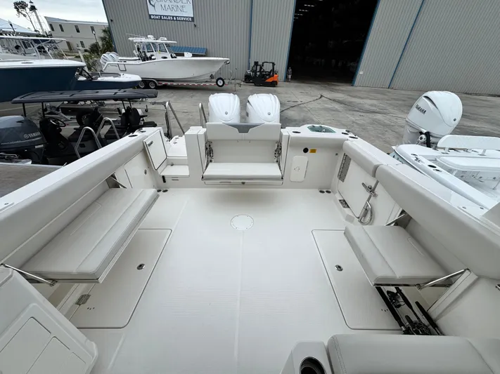  Yacht Photos Pics 2025 Sailfish 316 DC boat interior with spacious seating and twin outboard engines.