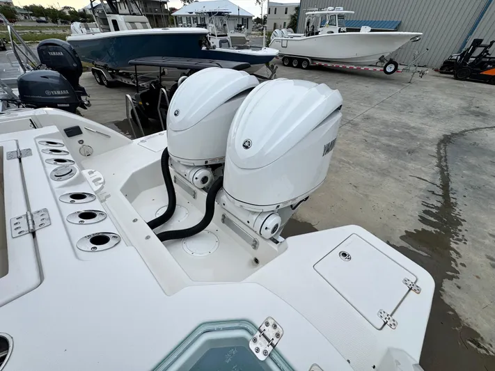  Yacht Photos Pics 2025 Sailfish 316 DC boat with dual outboard engines, docked in a marina.