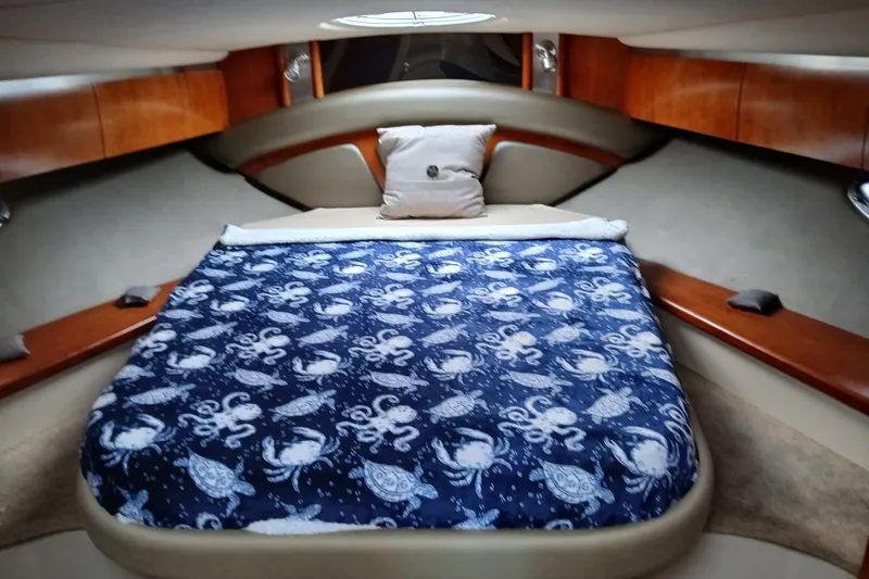  Yacht Photos Pics Luxurious cabin interior of 2007 Cruisers Yachts 420 Express with nautical-themed bedding.