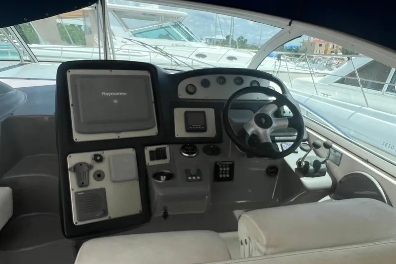  Yacht Photos Pics 2007 Cruisers Yachts 420 Express helm with steering wheel and navigation controls.