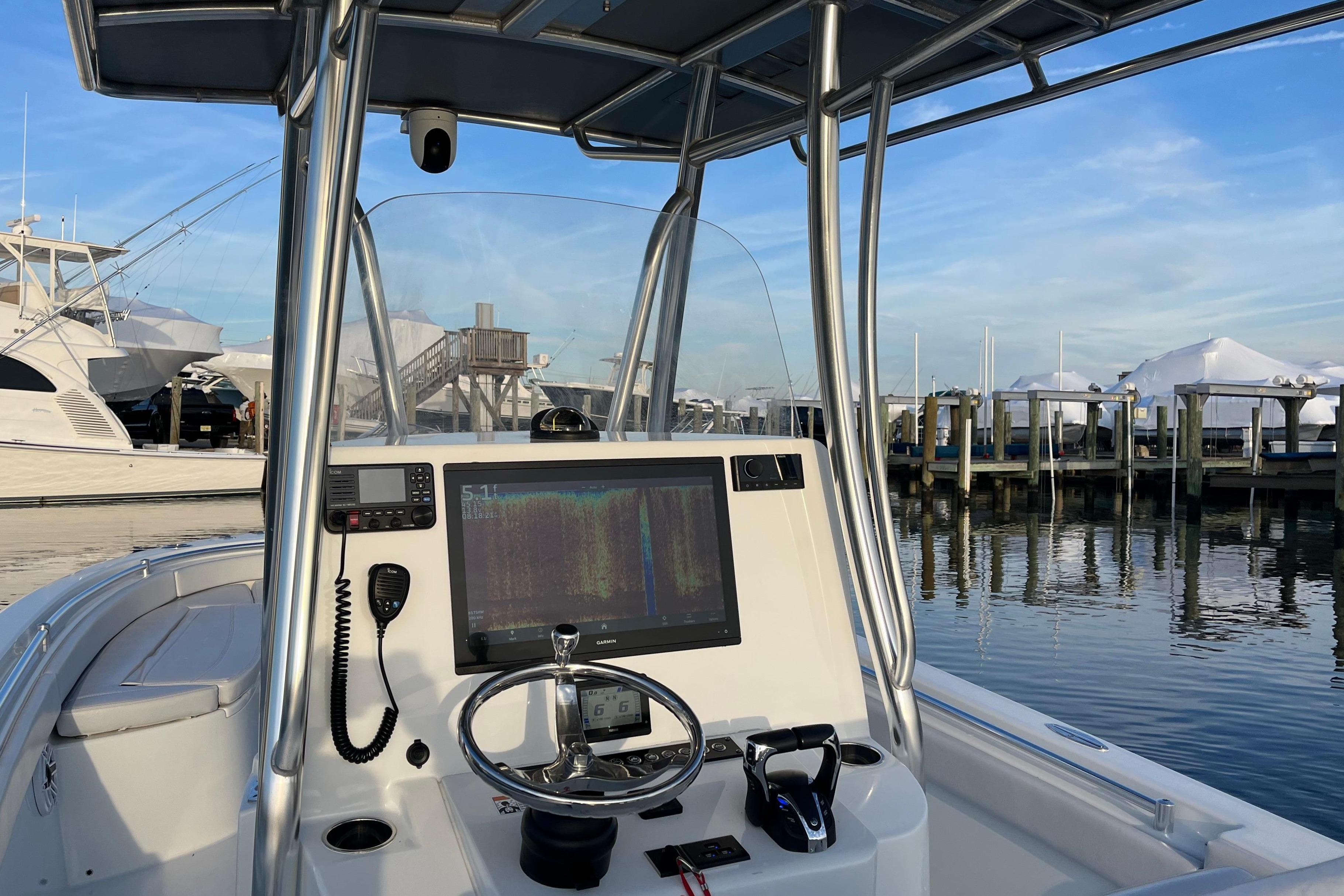 2023 Contender 24 Sport boat dashboard with navigation screen at marina.