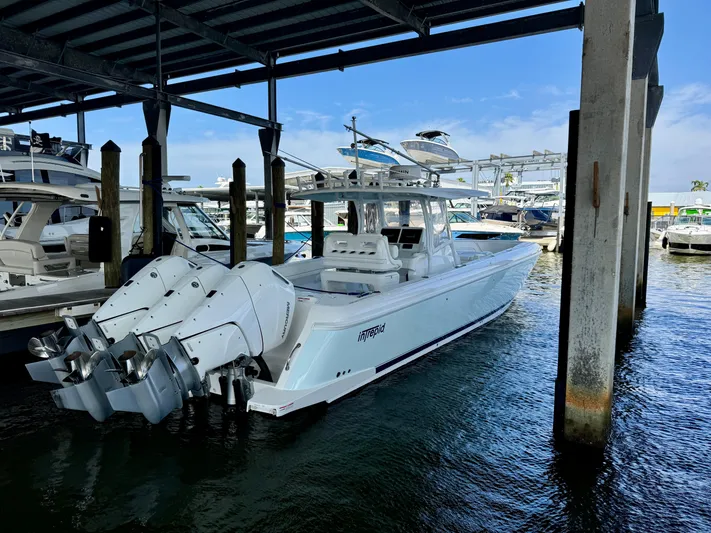  Yacht Photos Pics 2024 Intrepid 407 Nomad FE boat docked under a covered marina.