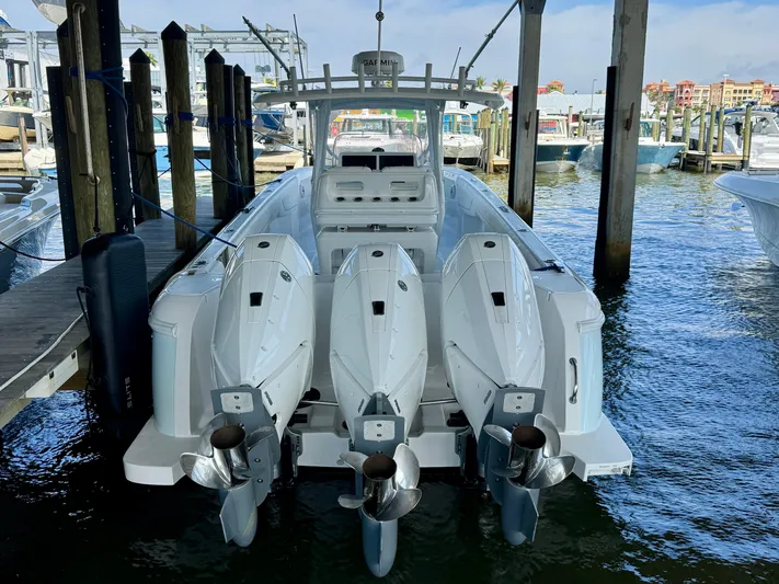  Yacht Photos Pics 2024 Intrepid 407 Nomad FE boat docked with triple outboard engines.