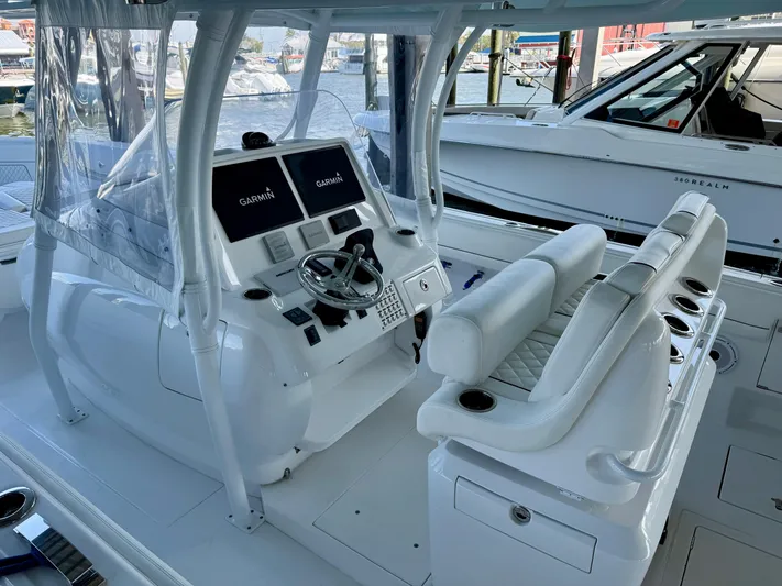  Yacht Photos Pics 2024 Intrepid 407 Nomad FE boat cockpit with dual Garmin displays and seating.