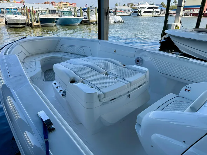  Yacht Photos Pics 2024 Intrepid 407 Nomad FE boat interior with luxurious seating, docked at a marina.