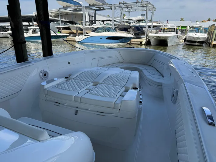  Yacht Photos Pics 2024 Intrepid 407 Nomad FE boat interior with luxurious seating at a marina.