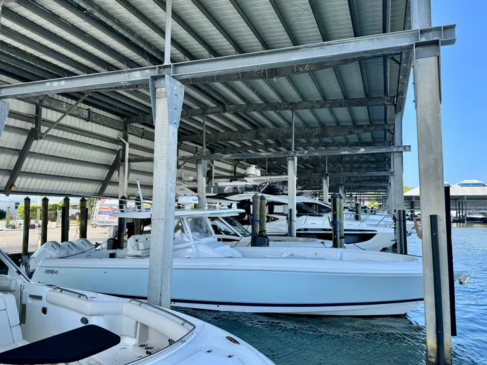  Yacht Photos Pics 2024 Intrepid 407 Nomad FE docked under a covered marina.
