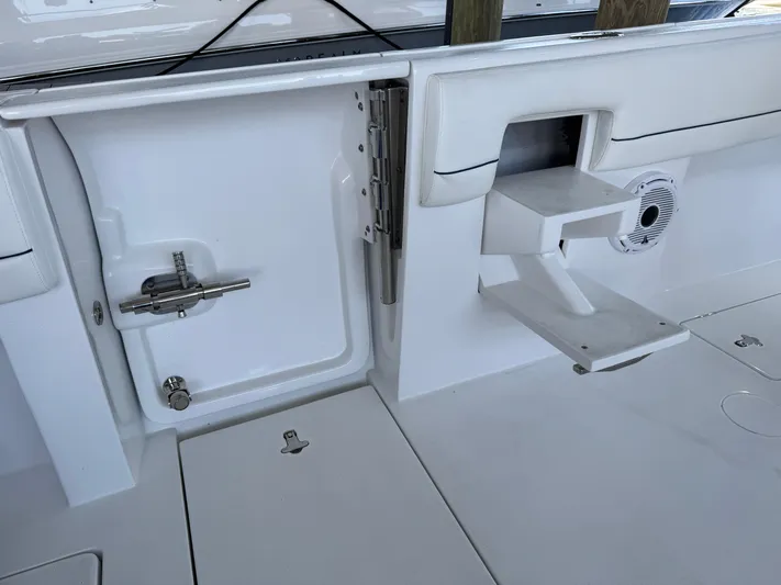  Yacht Photos Pics 2024 Intrepid 407 Nomad FE boat interior, featuring a sleek white design with storage compartments.