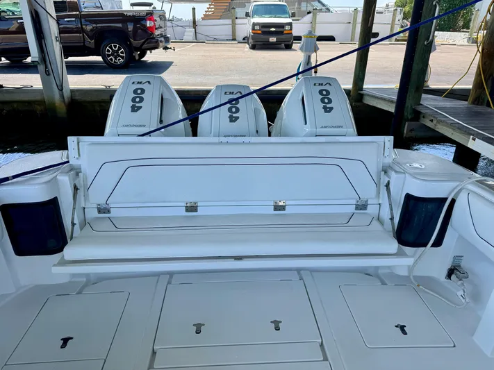  Yacht Photos Pics 2024 Intrepid 407 Nomad FE boat with triple outboard engines at a dock.