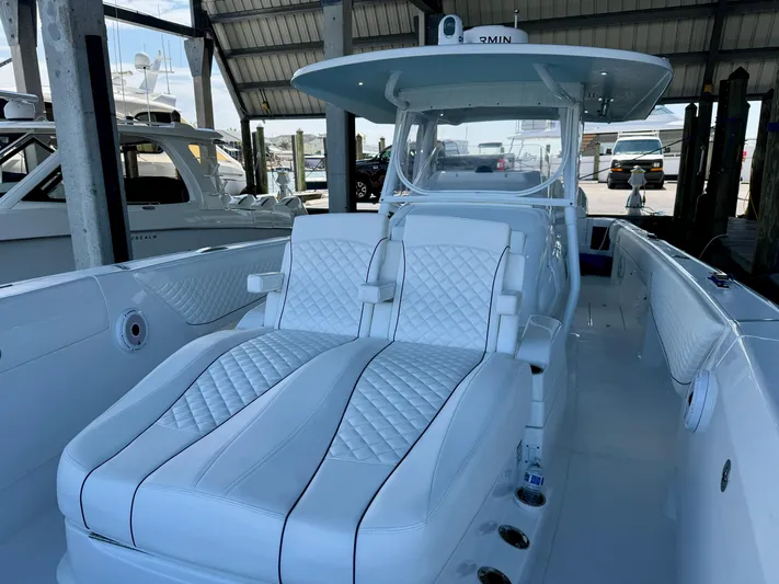  Yacht Photos Pics 2024 Intrepid 407 Nomad FE boat with luxurious white seating in a marina setting.