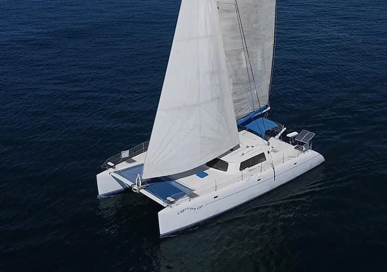 Capricorn Cat Yacht Photos Pics Sailing catamaran "Kurt Hughes 45" gliding on open water, 1995 model.