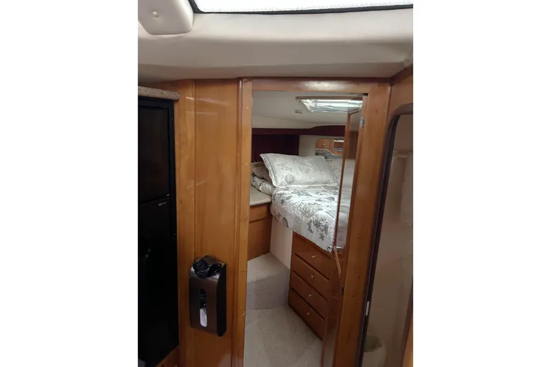 Yacht Photos Pics Interior cabin of 2001 Carver 356 Motor Yacht with cozy bed and wooden cabinetry.