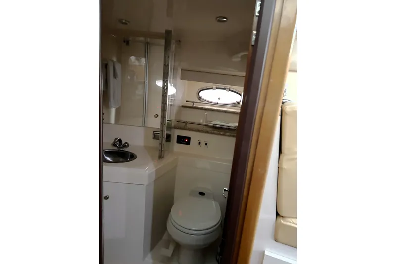  Yacht Photos Pics 2001 Carver 356 Motor Yacht bathroom interior with sink, toilet, and porthole window.