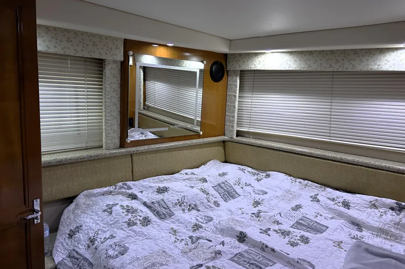  Yacht Photos Pics Cozy bedroom interior of 2001 Carver 356 Motor Yacht with floral bedding and window blinds.