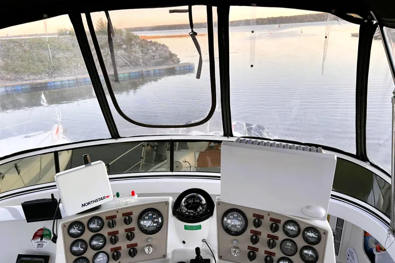  Yacht Photos Pics Interior view of 2001 Carver 356 Motor Yacht cockpit with dashboard and water scenery.