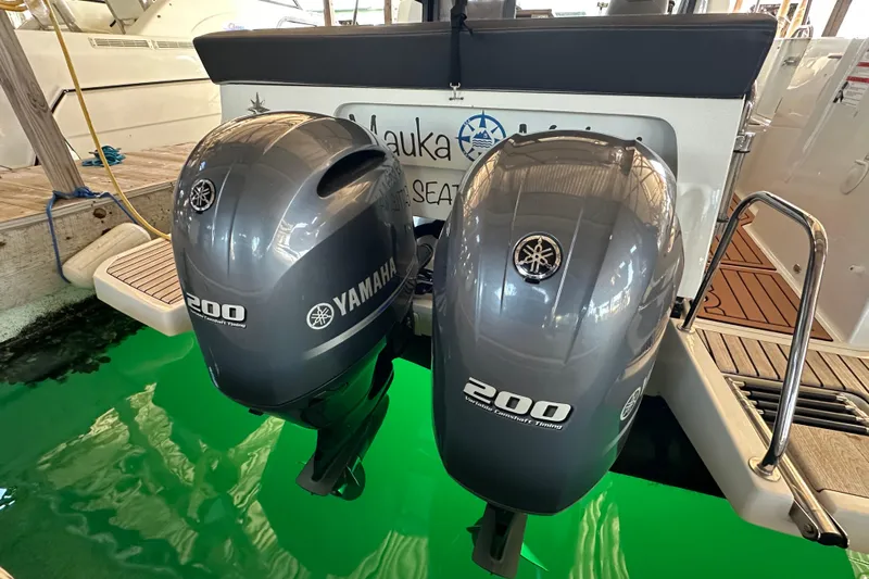 Mauka Makai Yacht Photos Pics Twin Yamaha 200 outboard engines on a 2021 Jeanneau NC 895 boat at dock.
