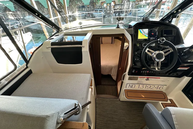 Mauka Makai Yacht Photos Pics Interior of 2021 Jeanneau NC 895 boat, featuring helm and cabin entrance.
