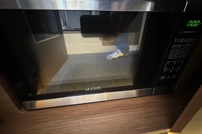 Mauka Makai Yacht Photos Pics Microwave oven inside Jeanneau NC 895 boat, 2021 model, with digital display and control panel.