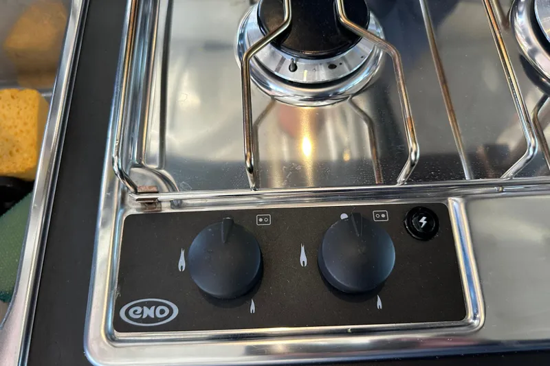 Mauka Makai Yacht Photos Pics Stainless steel stove with control knobs on Jeanneau NC 895 boat, 2021 model.