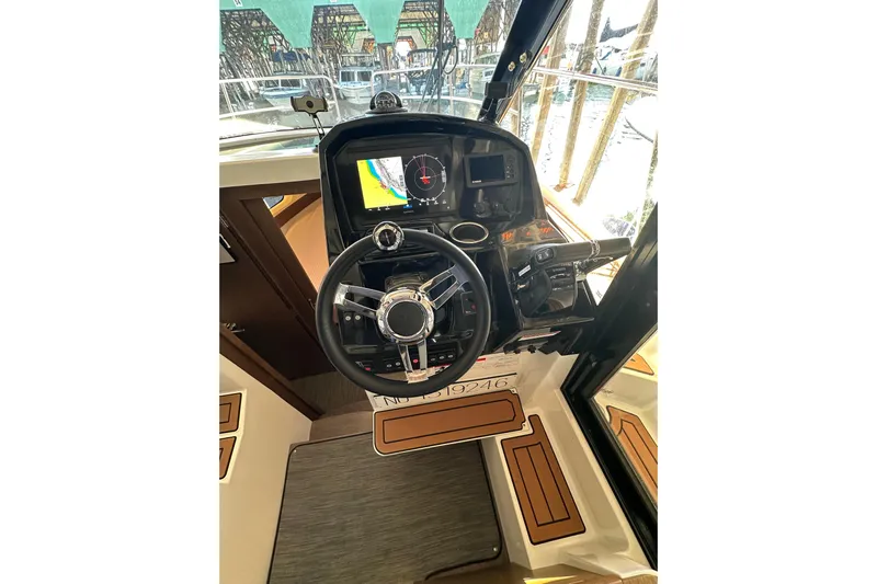 Mauka Makai Yacht Photos Pics 2021 Jeanneau NC 895 helm with steering wheel and navigation display.