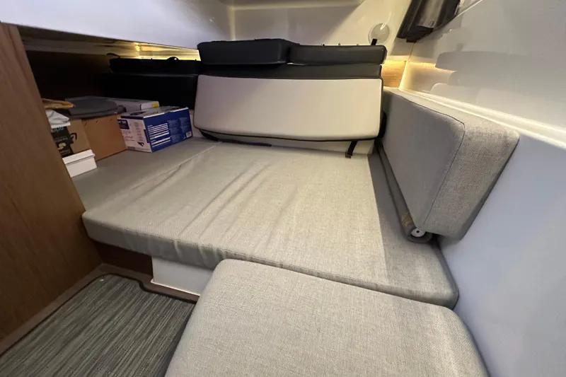 Mauka Makai Yacht Photos Pics Interior cabin of 2021 Jeanneau NC 895 with gray cushions and storage.