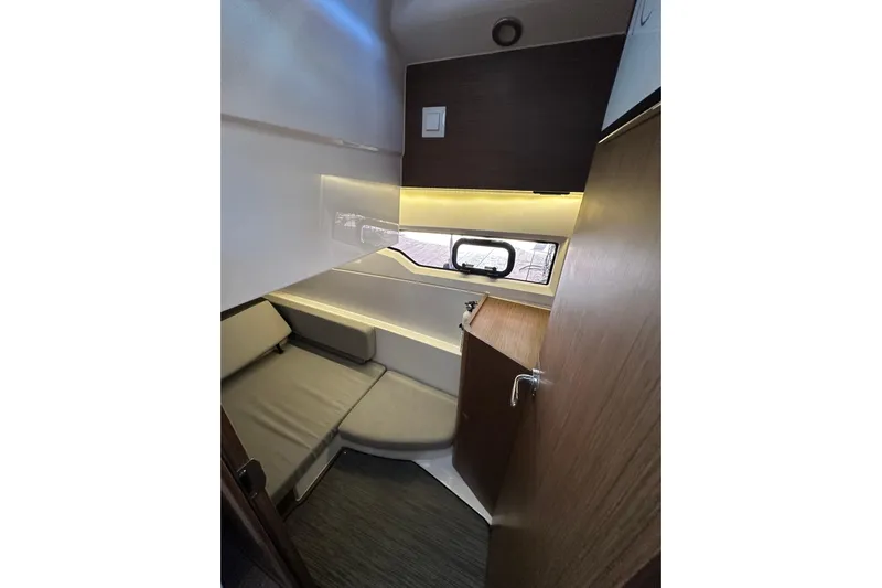 Mauka Makai Yacht Photos Pics Interior cabin of 2021 Jeanneau NC 895 boat with seating and window.