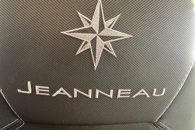 Mauka Makai Yacht Photos Pics Jeanneau logo on 2021 NC 895 boat seat, featuring embroidered star design.