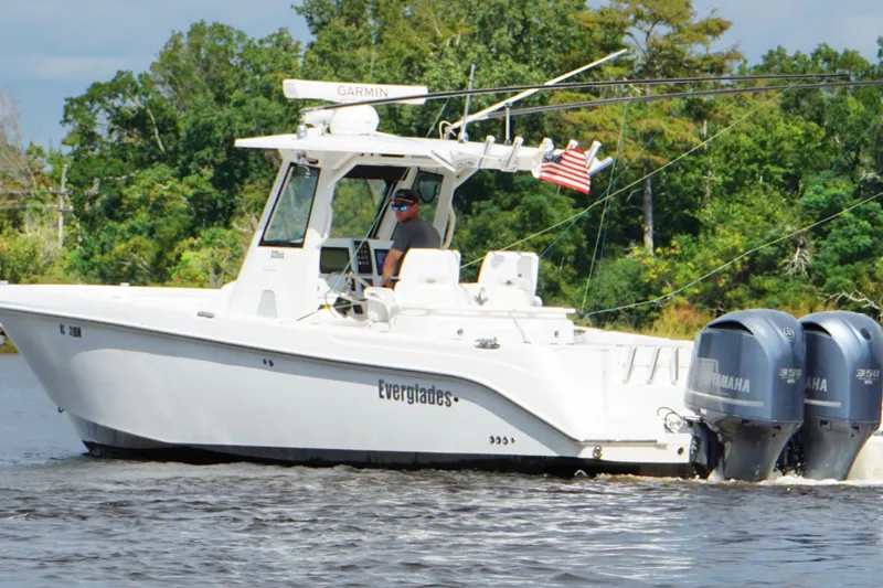  Yacht Photos Pics 2012 Everglades 325 Center Console boat cruising on a river with twin Yamaha engines.