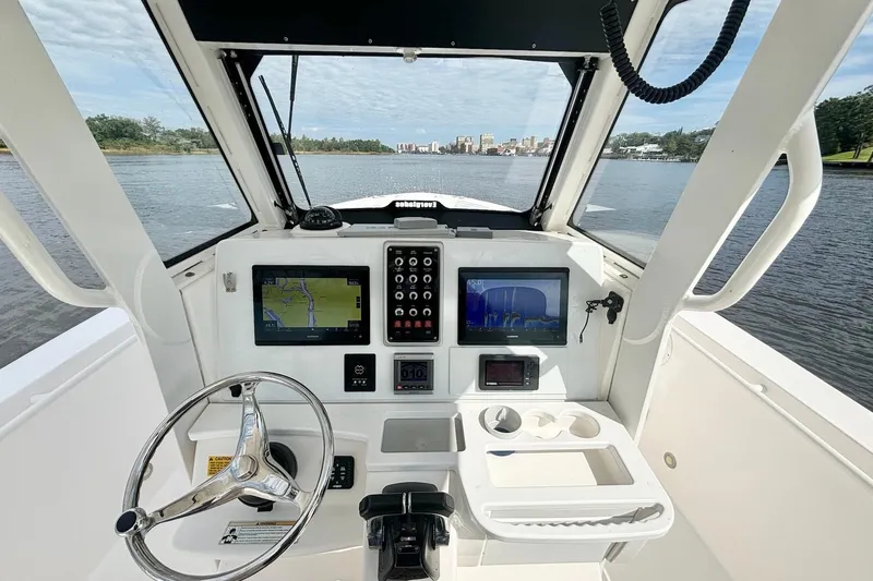  Yacht Photos Pics 2012 Everglades 325 Center Console boat interior with navigation screens and steering wheel.