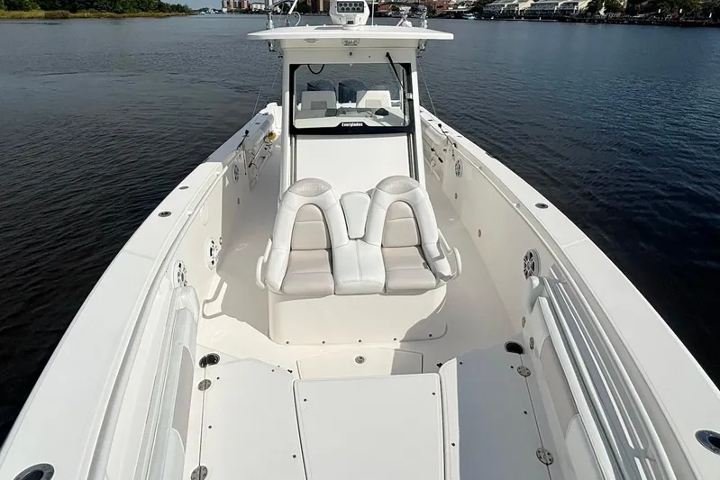  Yacht Photos Pics 2012 Everglades 325 Center Console boat on calm water, showcasing spacious deck and seating.