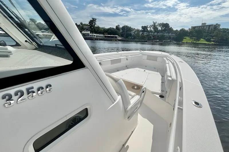  Yacht Photos Pics 2012 Everglades 325 Center Console boat on calm water, showcasing sleek design and spacious deck.