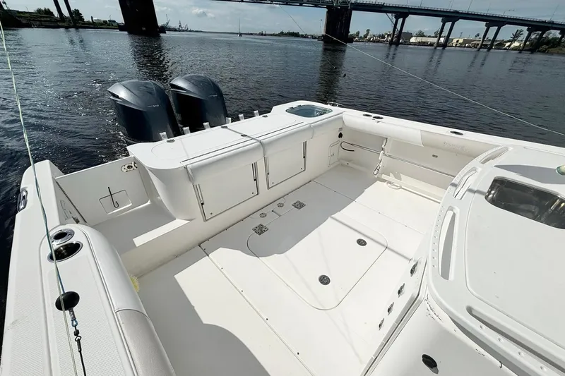  Yacht Photos Pics 2012 Everglades 325 Center Console boat with spacious deck and dual engines on calm water.