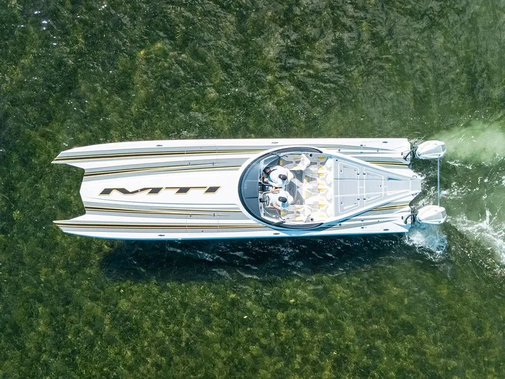  Yacht Photos Pics Aerial view of 2022 MTI 390X speedboat cruising on clear water.