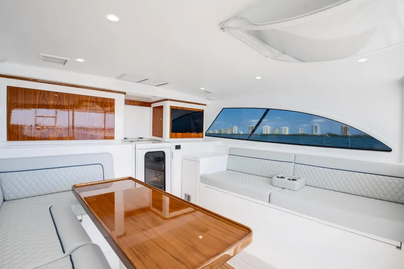 Can Do Yacht Photos Pics Luxurious interior of 2023 Viking 46 Billfish yacht with elegant seating and wood finishes.