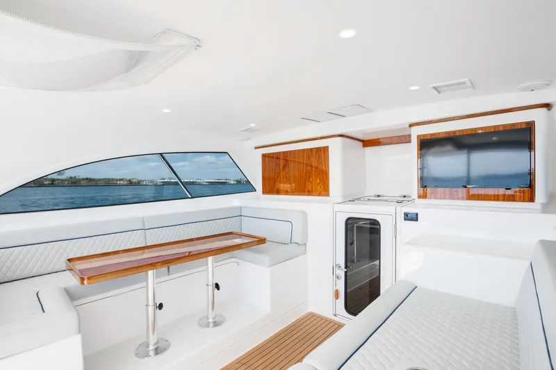 Can Do Yacht Photos Pics Luxurious interior of 2023 Viking 46 Billfish yacht with elegant seating and wood accents.