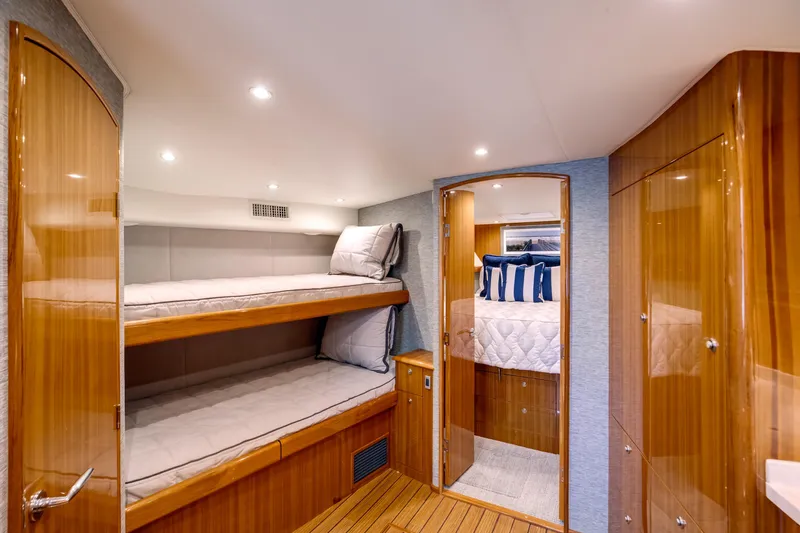 Can Do Yacht Photos Pics Luxurious interior of 2023 Viking 46 Billfish yacht with cozy bunk beds and elegant wood finish.