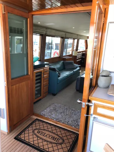  Yacht Photos Pics Interior view of 1977 Monk McQueen 72 CPMY yacht with cozy seating and welcome mat.