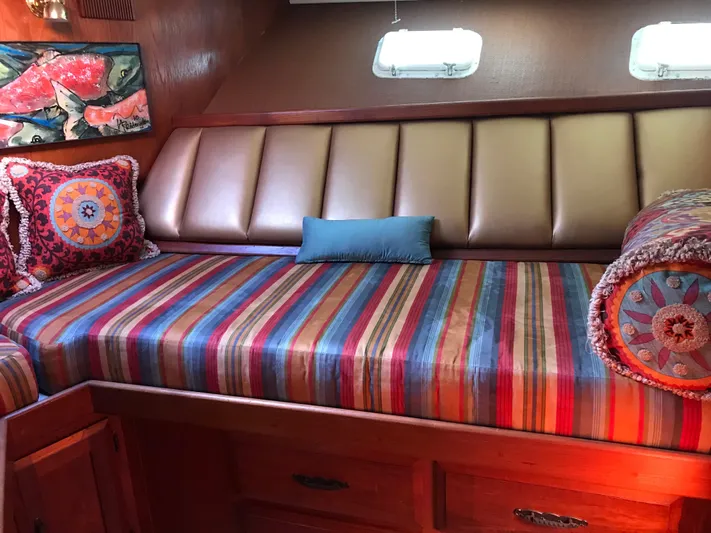  Yacht Photos Pics 1977 Monk McQueen 72 CPMY interior with striped bedding and decorative pillows.