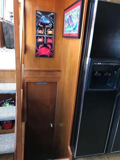  Yacht Photos Pics Interior of 1977 Monk McQueen 72 CPMY with wood paneling, art, and a refrigerator.