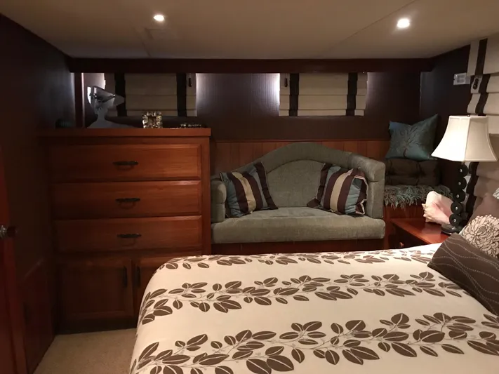  Yacht Photos Pics Cozy cabin interior of 1977 Monk McQueen 72 CPMY with bed, dresser, and seating area.