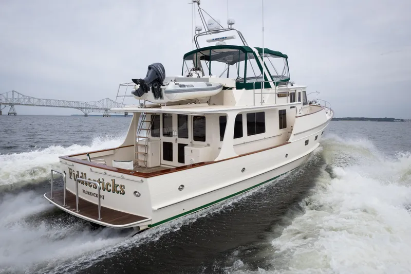 Fiddlesticks Yacht Photos Pics 2007 Fleming 55 yacht cruising on water with bridge in background.