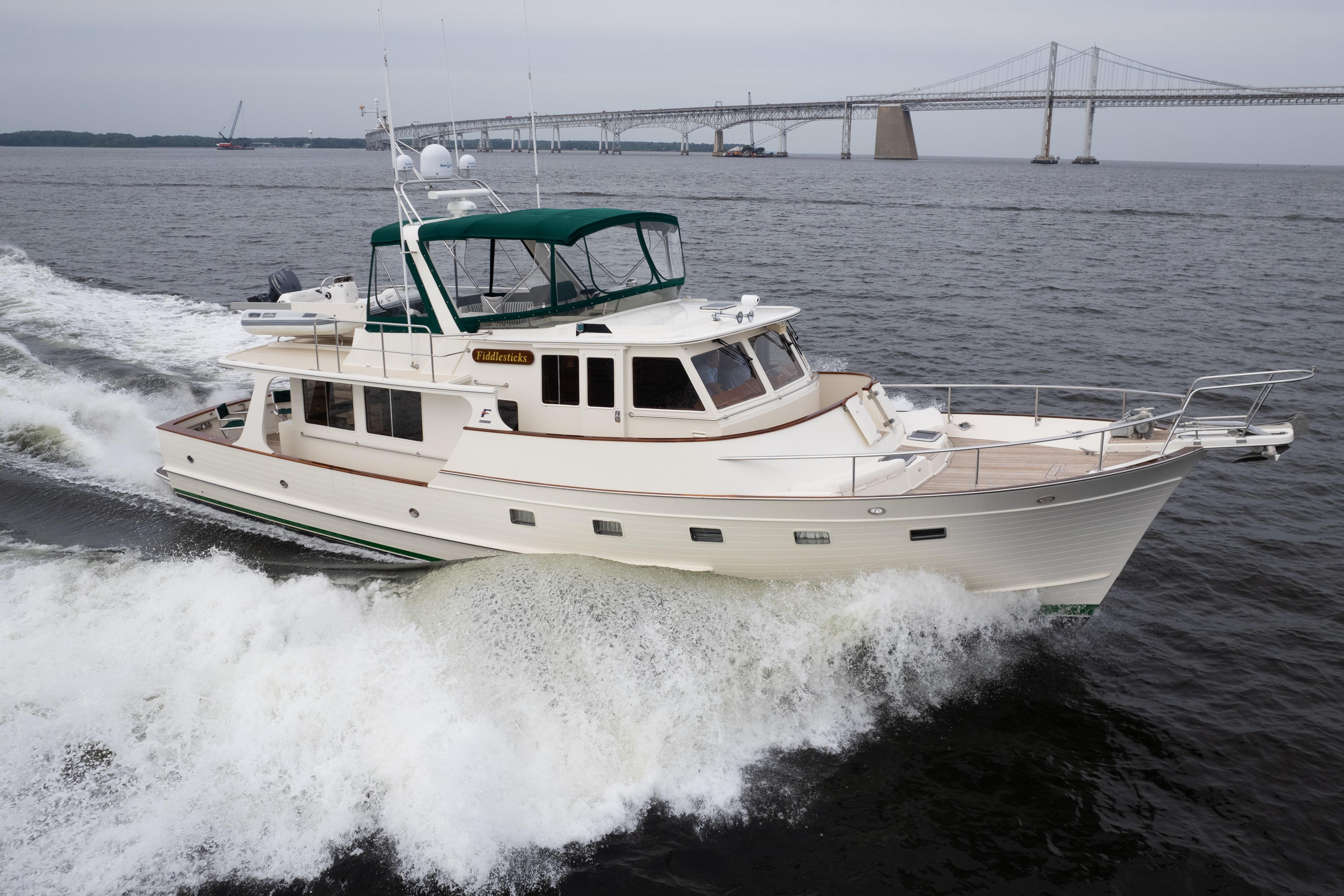 2007 Fleming 55 yacht cruising near a bridge on open water.
