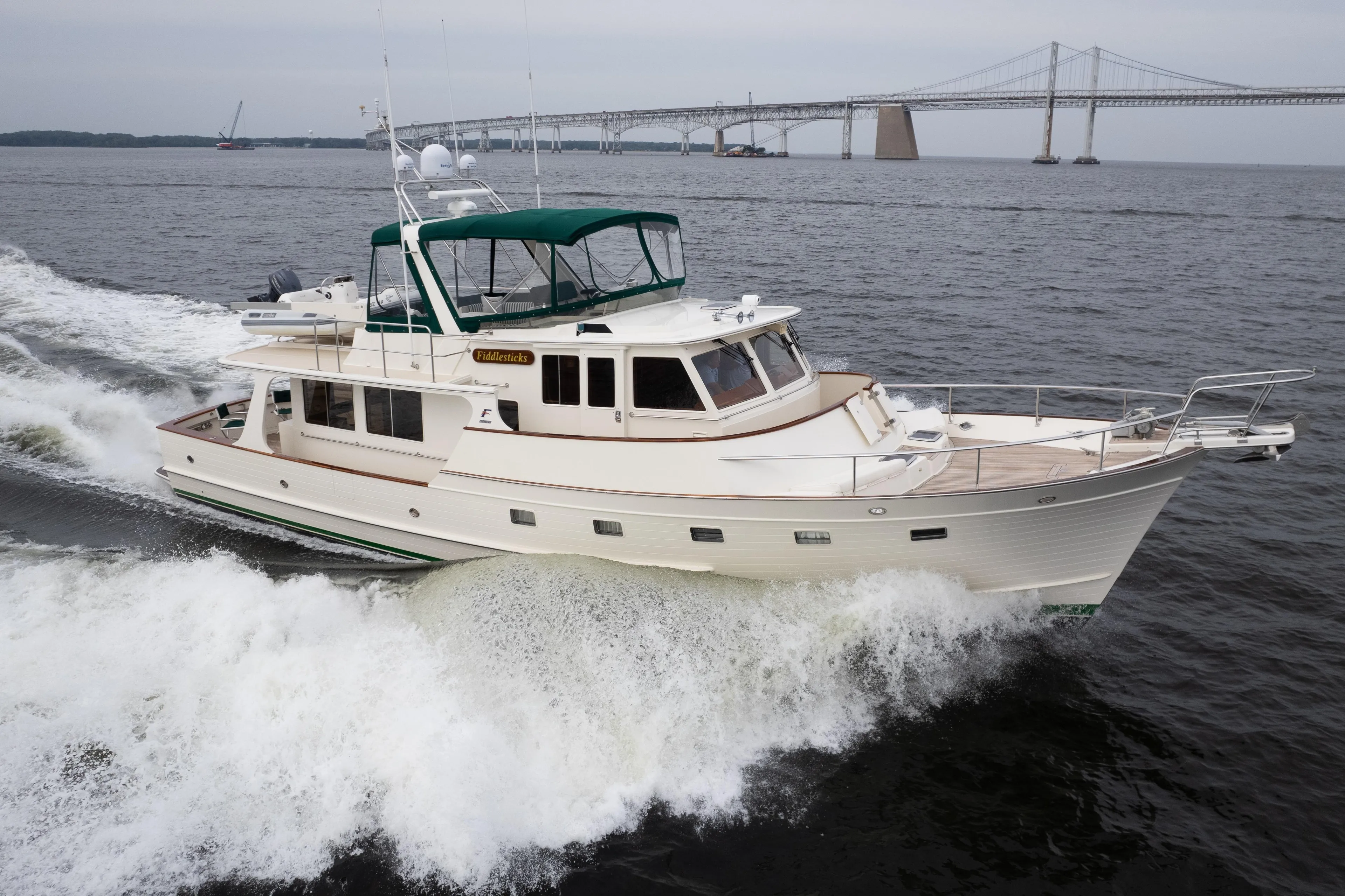 2007 Fleming 55 yacht cruising near a bridge on open water.