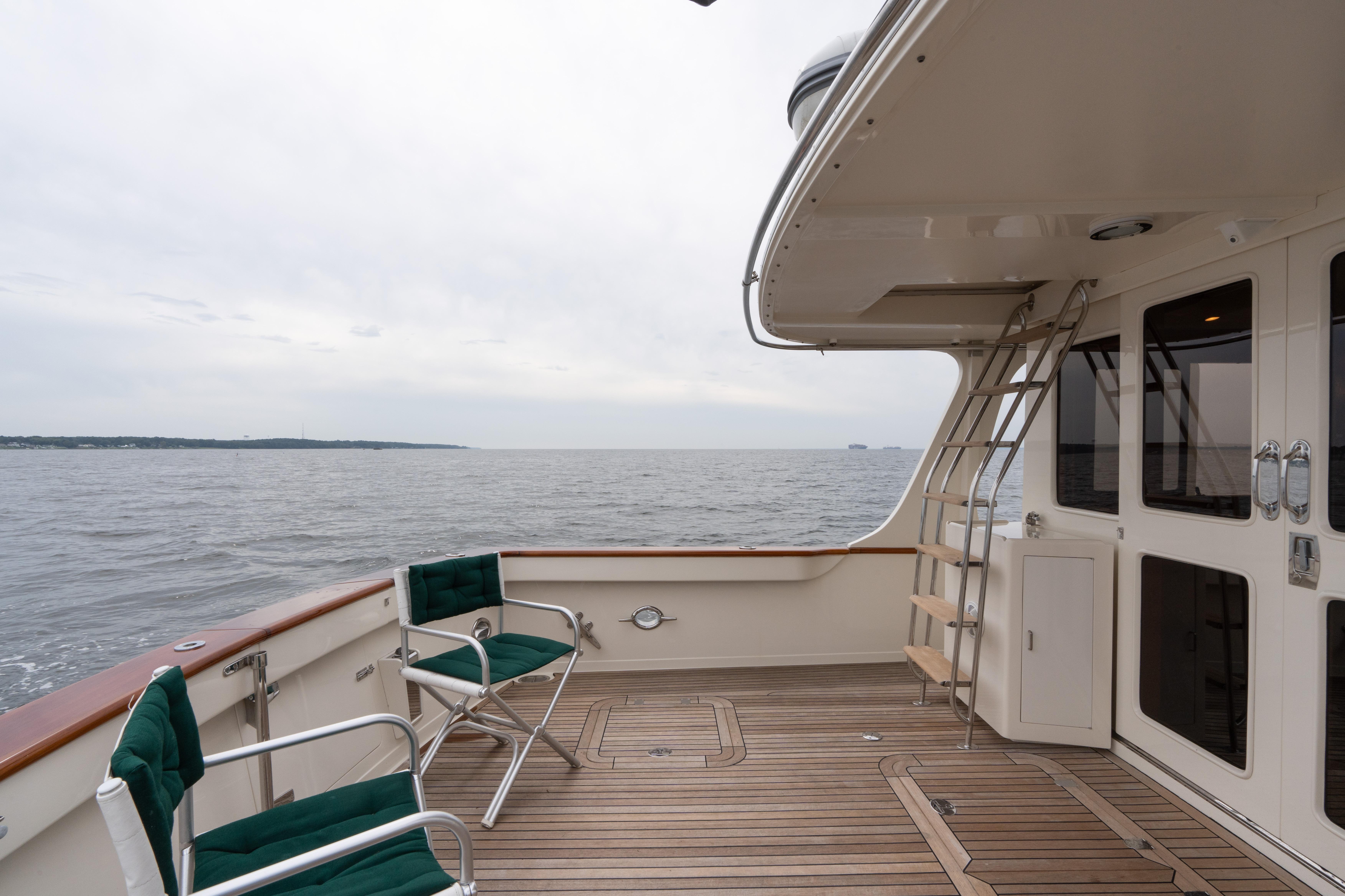 Deck view of 2007 Fleming 55 yacht with ocean backdrop and seating area.