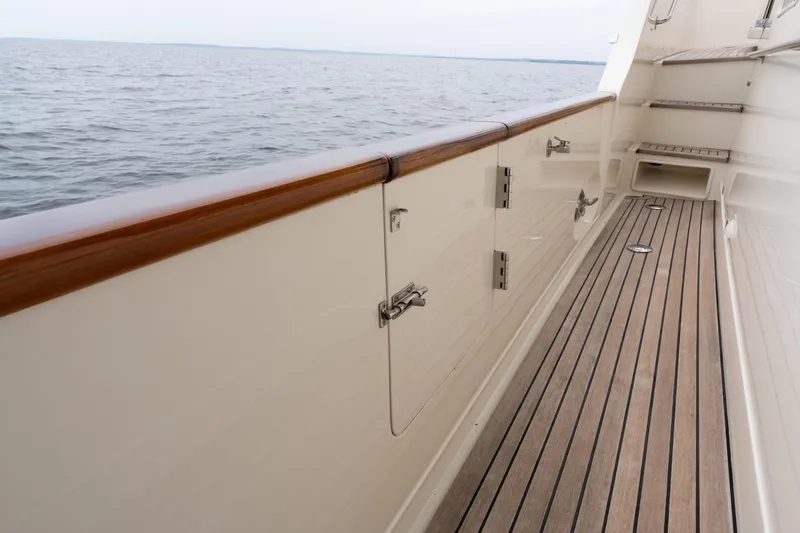 Fiddlesticks Yacht Photos Pics Side deck of a 2007 Fleming 55 yacht with wooden railings and ocean view.