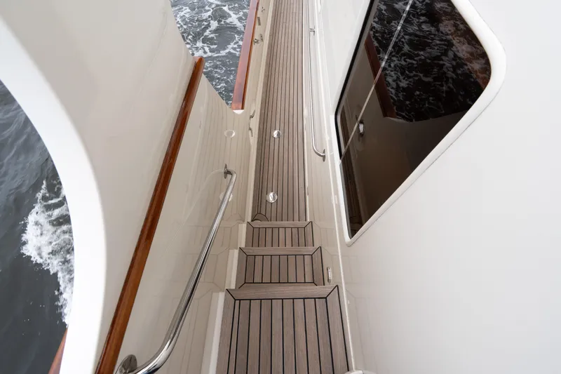Fiddlesticks Yacht Photos Pics Side deck of a 2007 Fleming 55 yacht with teak flooring and railing.