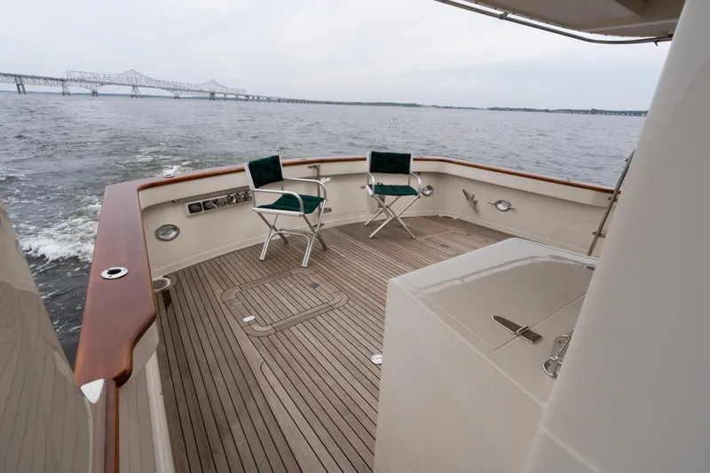 Fiddlesticks Yacht Photos Pics Deck of 2007 Fleming 55 yacht with chairs, overlooking water and bridge.