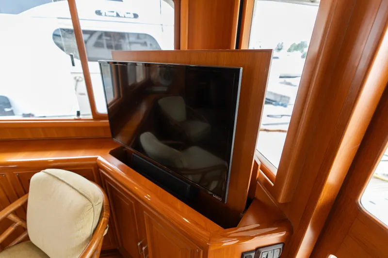 Fiddlesticks Yacht Photos Pics Luxurious 2007 Fleming 55 yacht interior with built-in TV and wooden cabinetry.